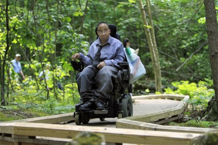 Chelsea Fernandez steers her wheelchair through the woods at the Crotched Mountain Rehabilitation Center in Greenfield, N.H. The center offers over 2.5 miles of privately funded trails designed to be easily accessible for people in wheelchairs and those who have difficulty walking. 